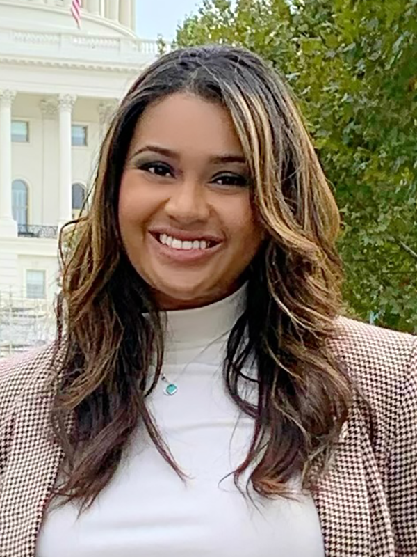 Photo of Anyssa with Brown hair and highlights wearing a checkered blazer